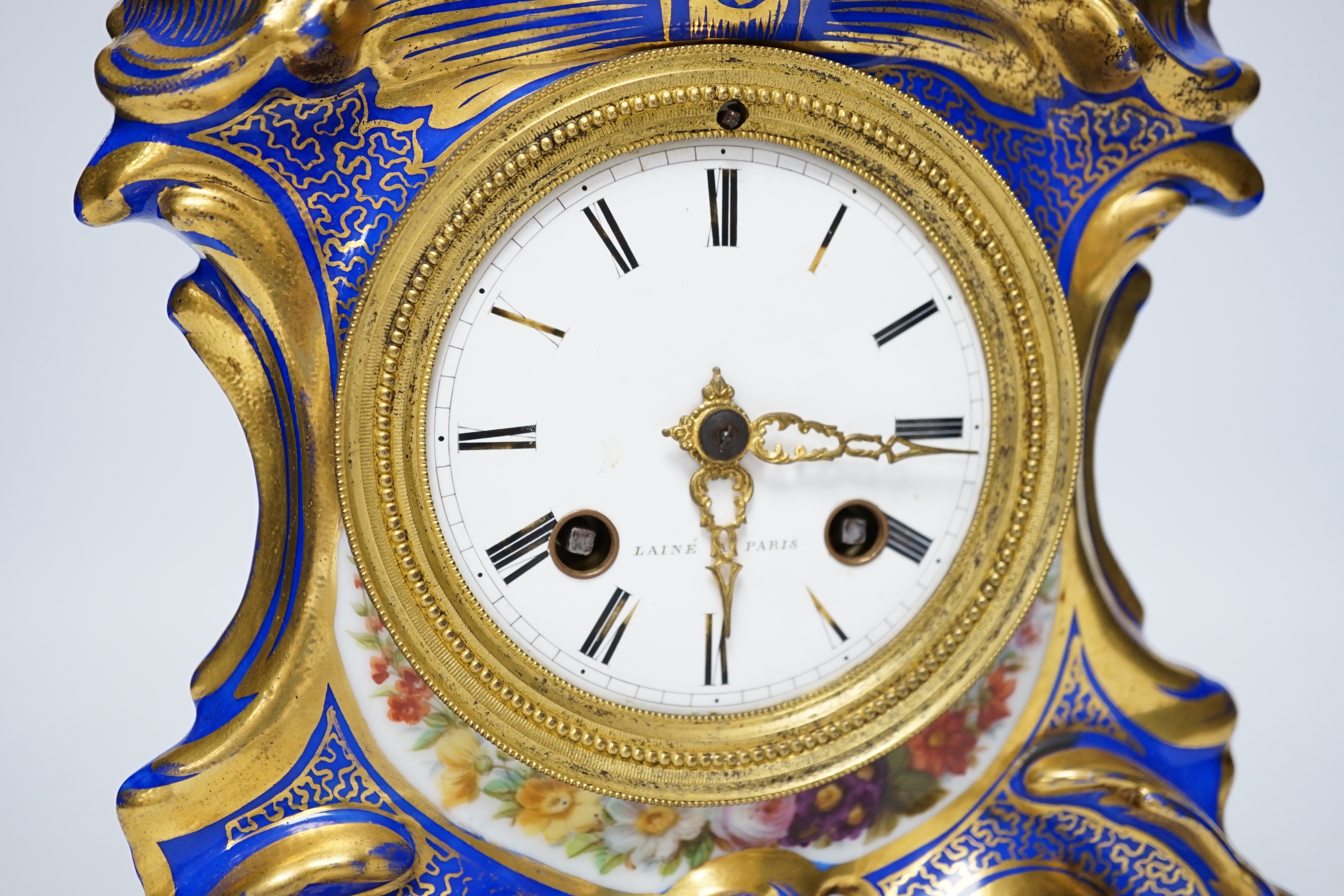An early 20th century French porcelain mantel clock, missing top section, 19cm